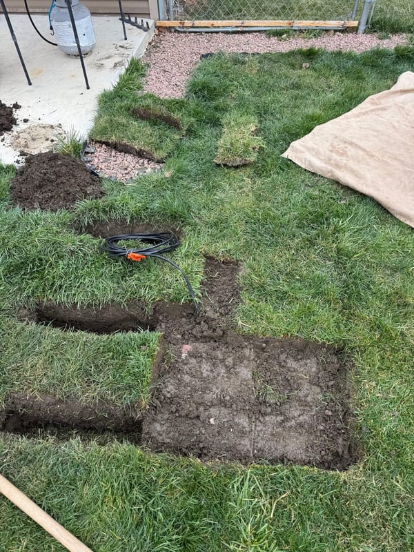 Sod cut and peeled back where a sprinkler valve box will go