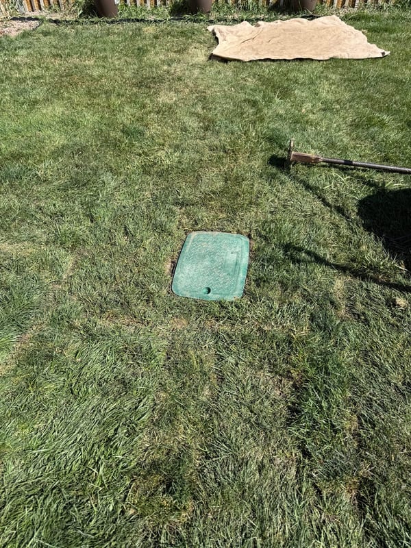 Sod replaced around a finished green valve box lid