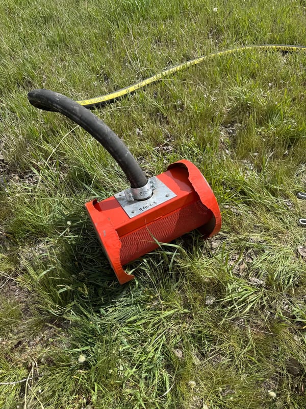 Red pump intake screen on a suction hose