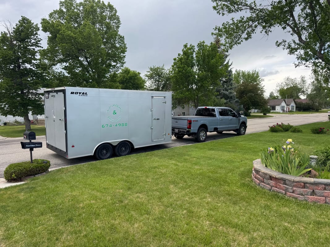 Work trailer and pickup parked at a residential job